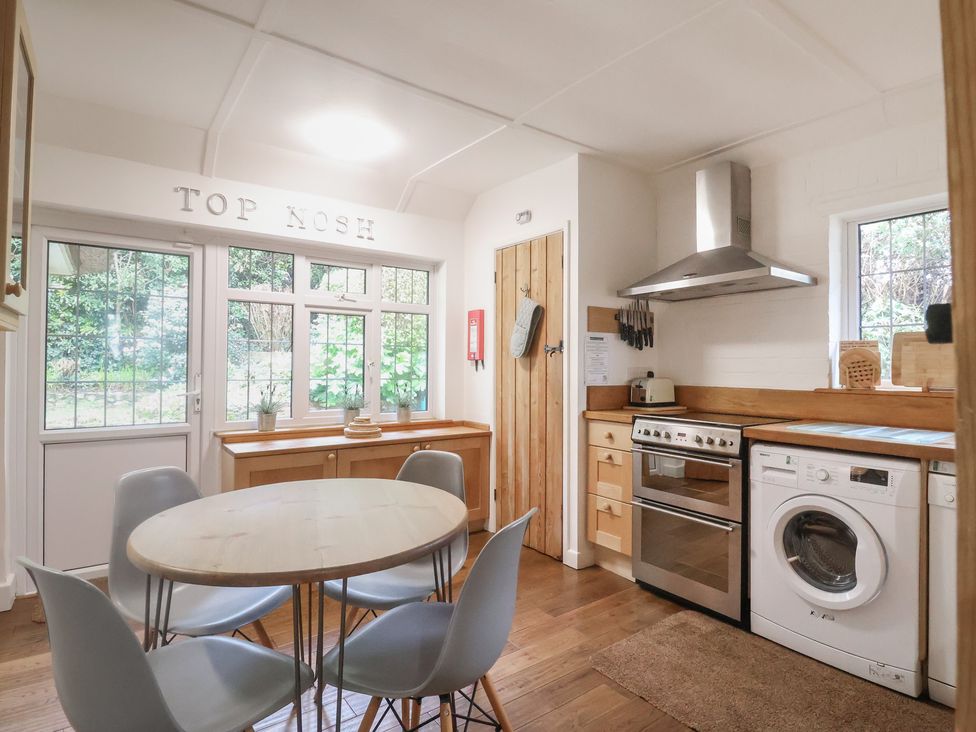 A kitchen with a table and chairs at Top Kosh in Lyme Regis