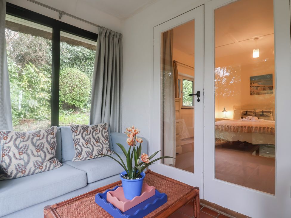 A snug with a sofa and a plant at Maries in Lyme Regis