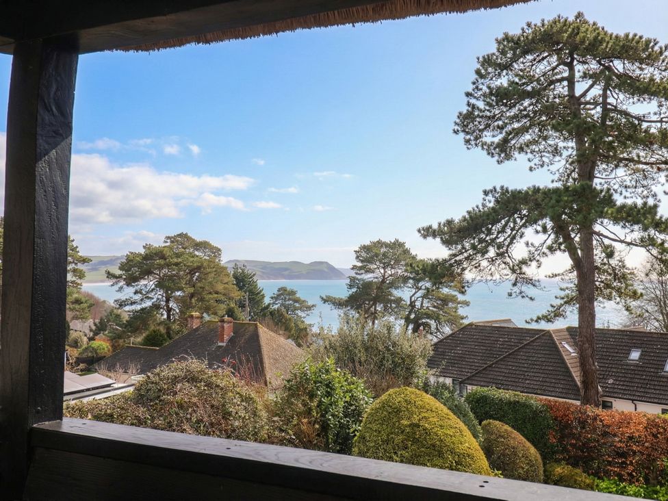 A view of the sea and trees from a property at Maries Lyme Regis