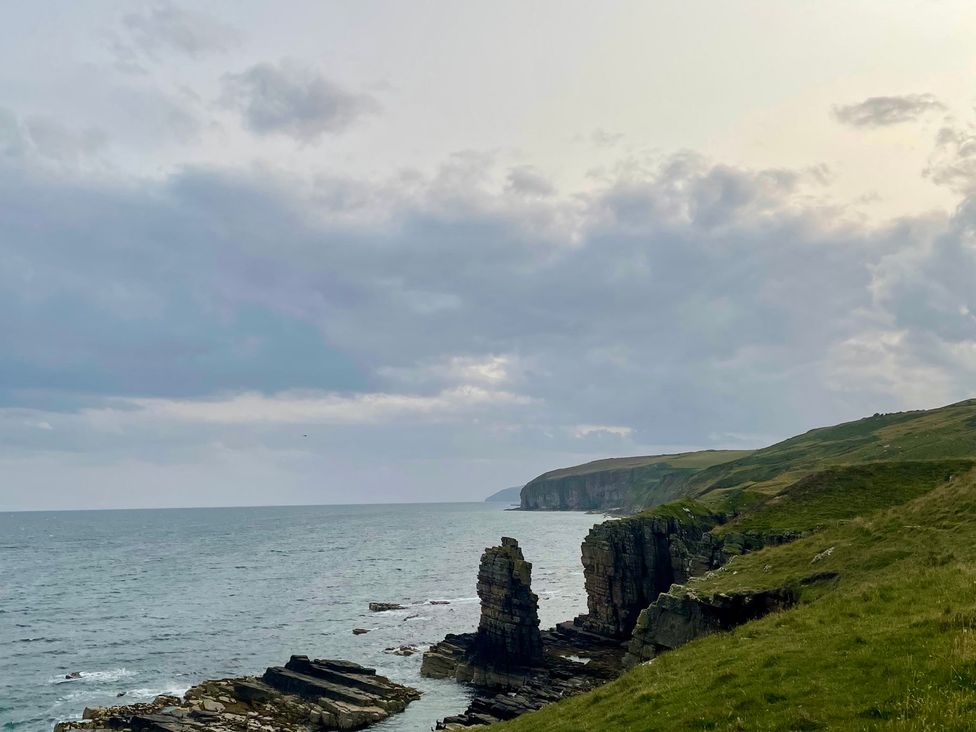 A coastal view with cliffs and rocks at Ceol-na-Mara Newport near Dunbeath