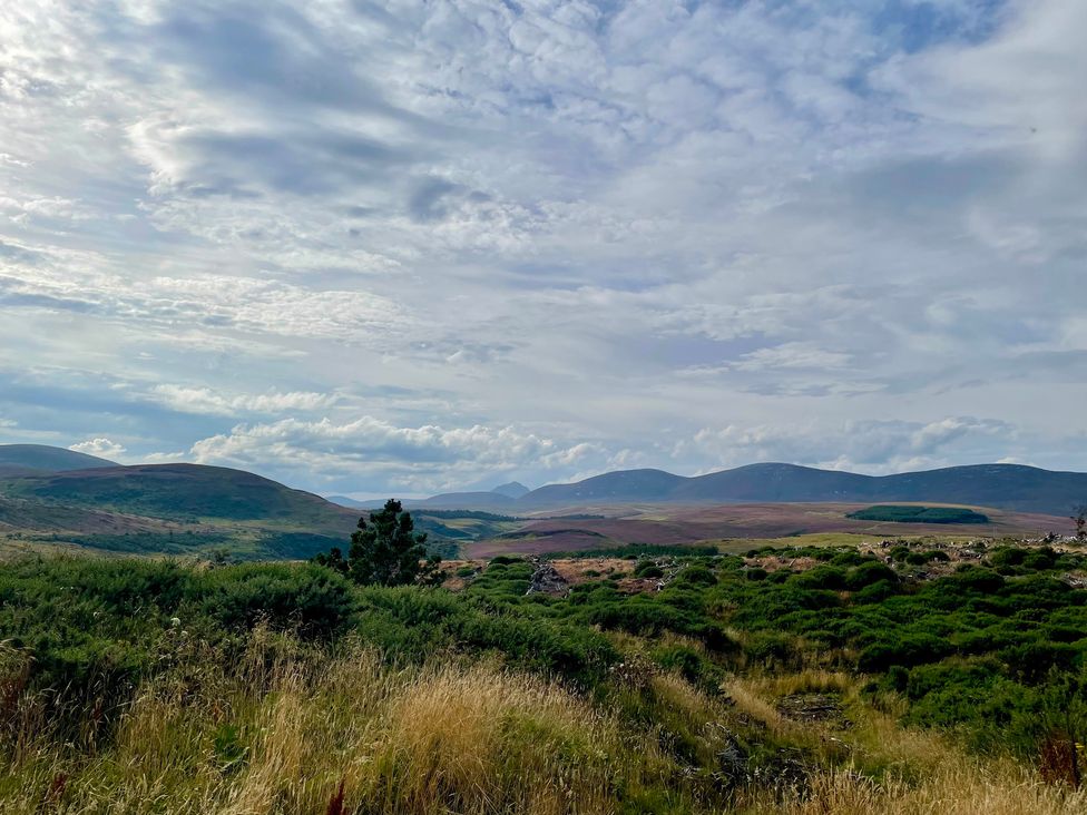 A view of mountains and grassland at Ceol-na-Mara Newport near Dunbeath