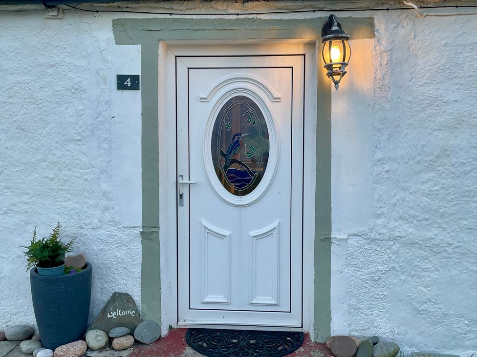 An entrance with a white door and a Welcome stone at Ceol-na-Mara Newport near Dunbeath