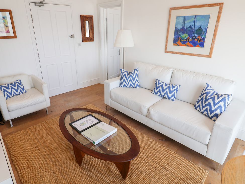 A living room with a sofa and coffee table at Seagull in Lyme Regis