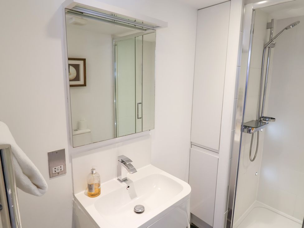 A bathroom with a sink and shower at Seagull in Lyme Regis