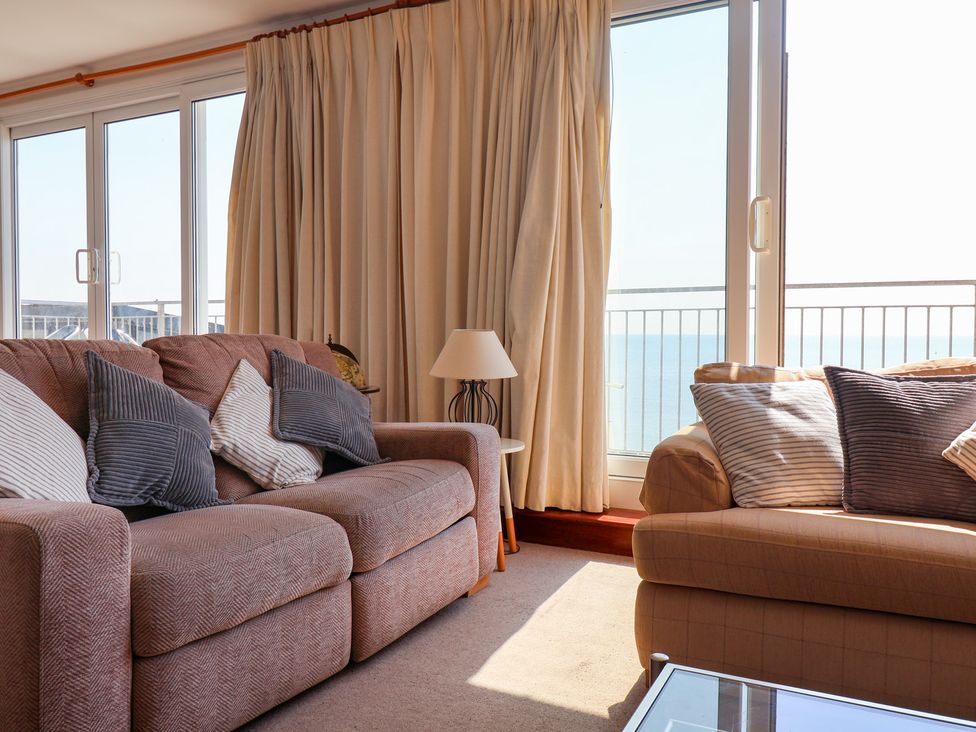 A living room with a sofa and lamp at Watersmeet in Lyme Regis