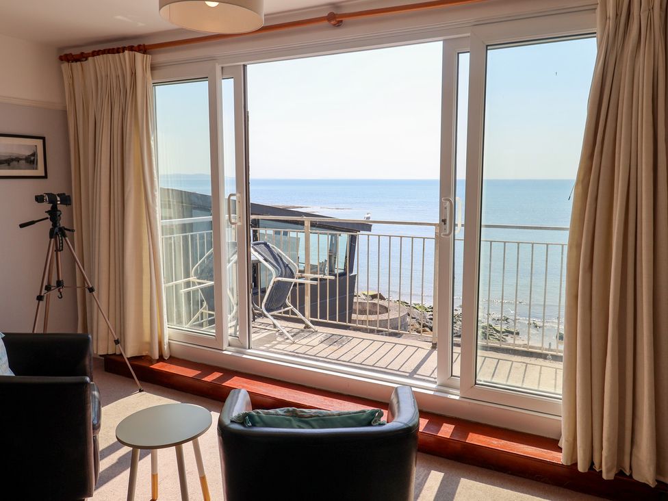A living room with a view of the sea at Watersmeet in Lyme Regis