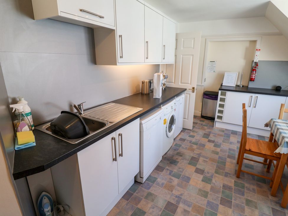 A kitchen with a washing machine and sink at Watersmeet in Lyme Regis