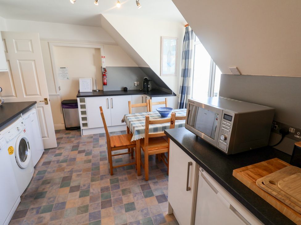 A kitchen with a table and chairs at Watersmeet in Lyme Regis