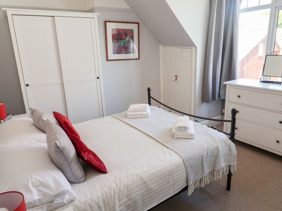 A bedroom with a bed and wardrobe at Watersmeet in Lyme Regis