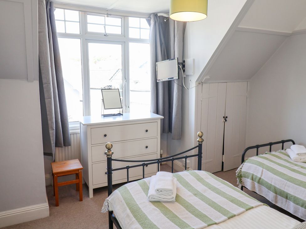 A bedroom with two beds and a chest of drawers at Watersmeet in Lyme Regis