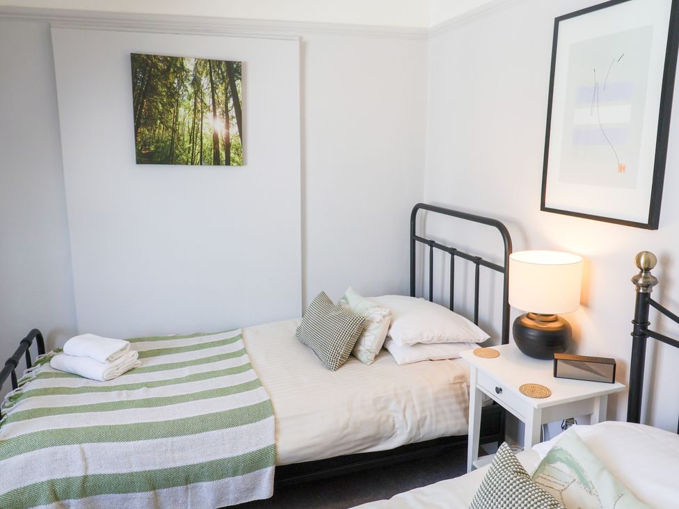 A bedroom with beds and a lamp at Watersmeet in Lyme Regis