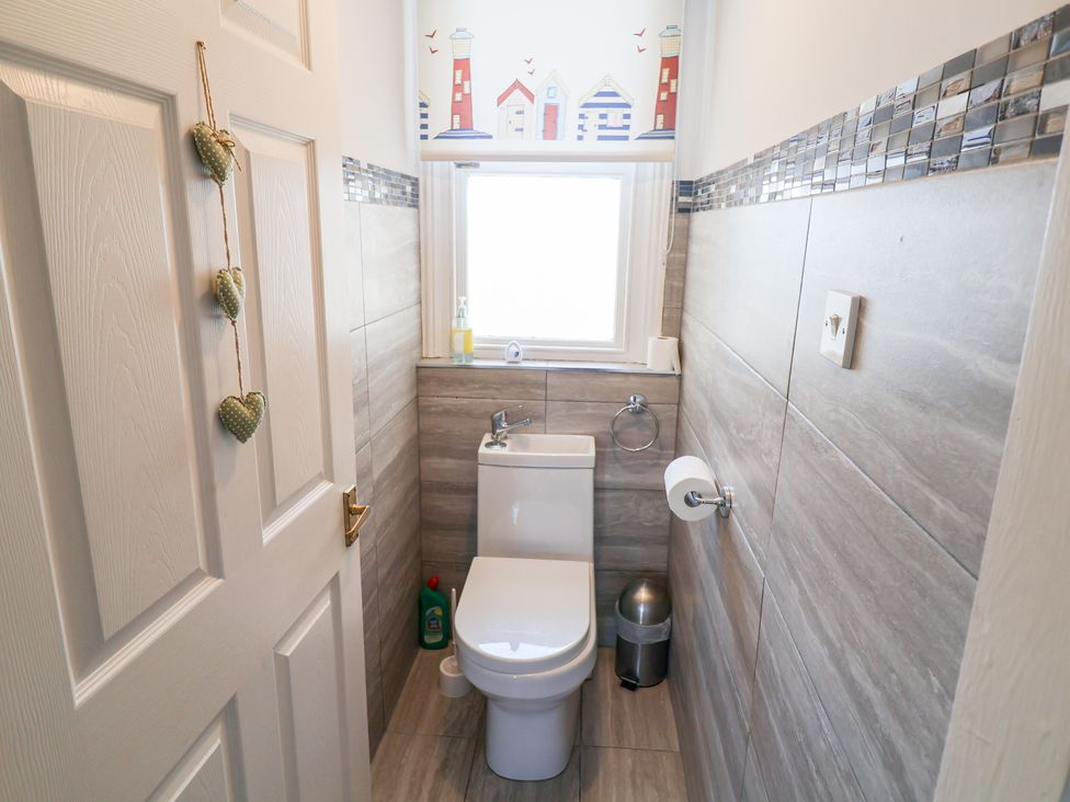 A bathroom with a toilet and window at Watersmeet in Lyme Regis