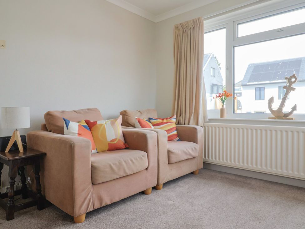 A living room with two sofas and a window at Gosling Way in Lyme Regis