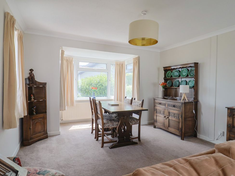 A dining room with a table and chairs at Gosling Way Lyme Regis