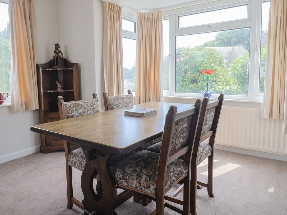 A dining room with a table and chairs at Gosling Way in Lyme Regis