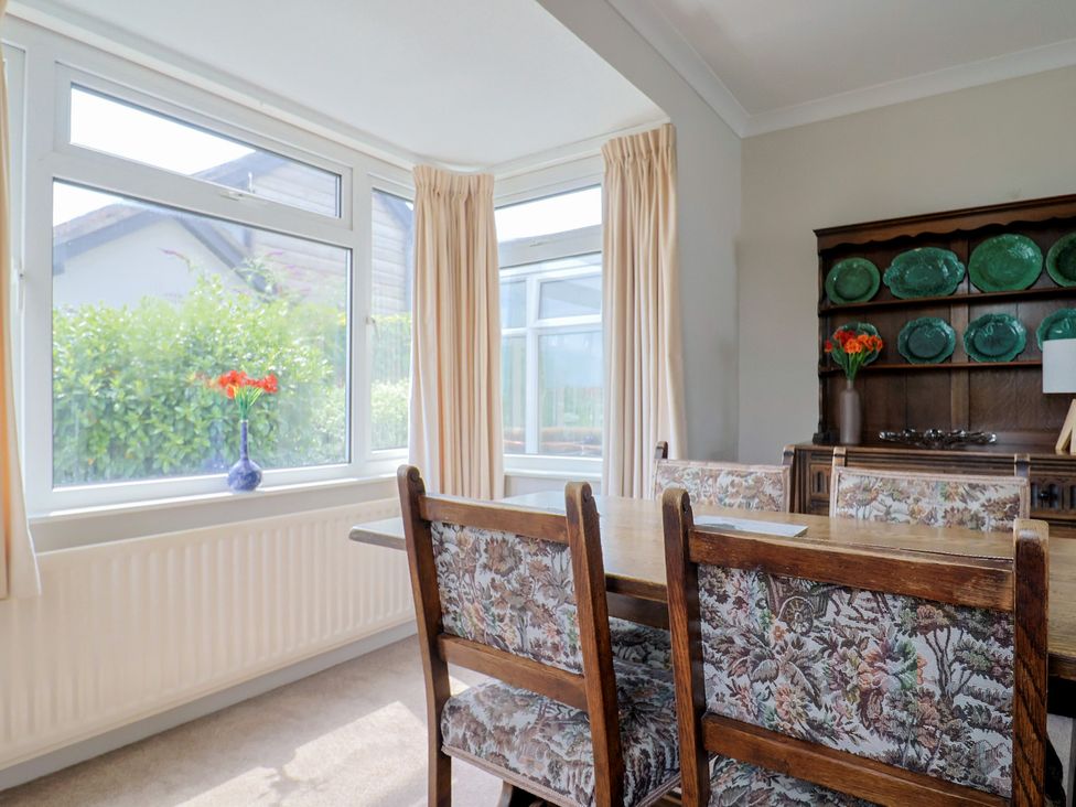 A dining room with a table and chairs at Gosling Way in Lyme Regis