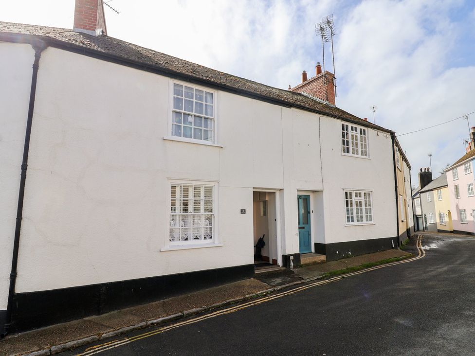 A house with a blue door and white walls at 3 Dolphin Cottages in Lyme Regis