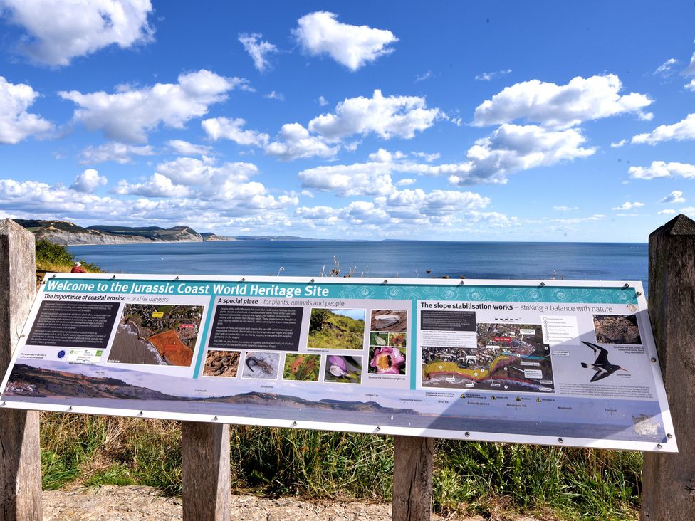 A sign at the Jurassic Coast World Heritage Site with ocean view at 3 Dolphin Cottages in Lyme Regis