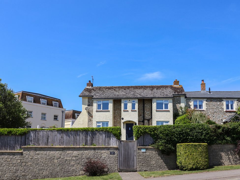 A house with a gate and hedge at Ancient Lights in Lyme Regis