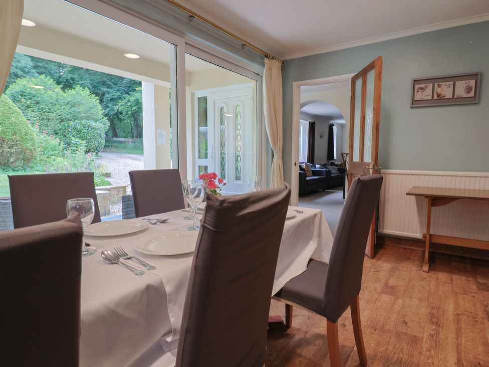 A dining room with a table and chairs at The Orchard Country House Rousdon