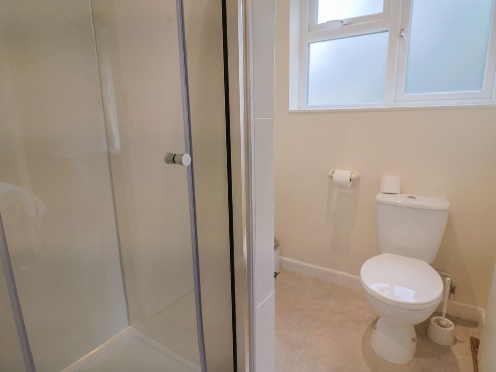 A bathroom with a shower and toilet at The Orchard Country House Rousdon