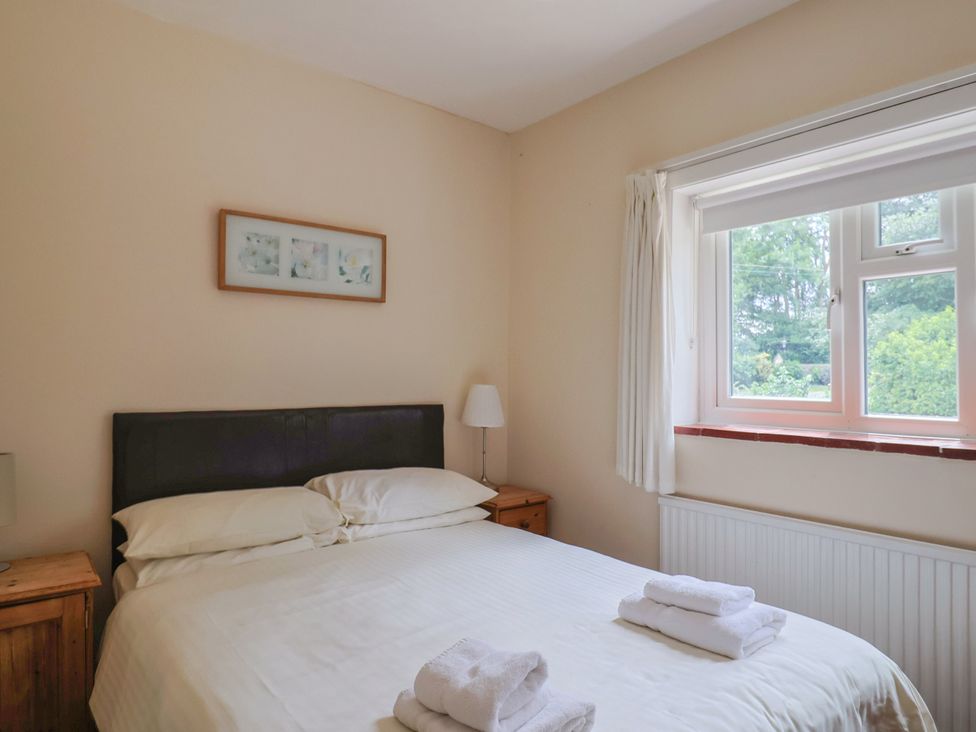 A bedroom with a bed and a window at The Orchard Country House in Rousdon