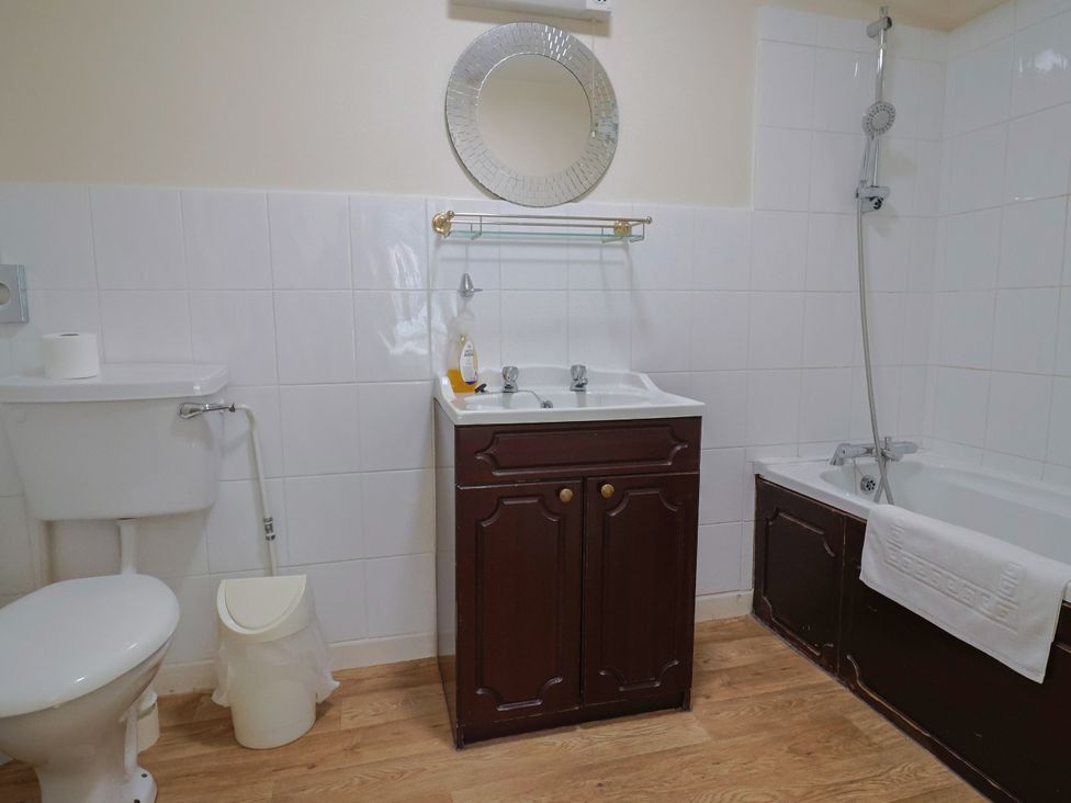 A bathroom with a toilet, sink, shower, and bathtub at The Orchard Country House Rousdon
