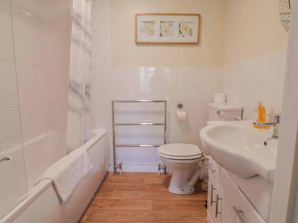 A bathroom with a bathtub toilet and sink at The Orchard Country House Rousdon