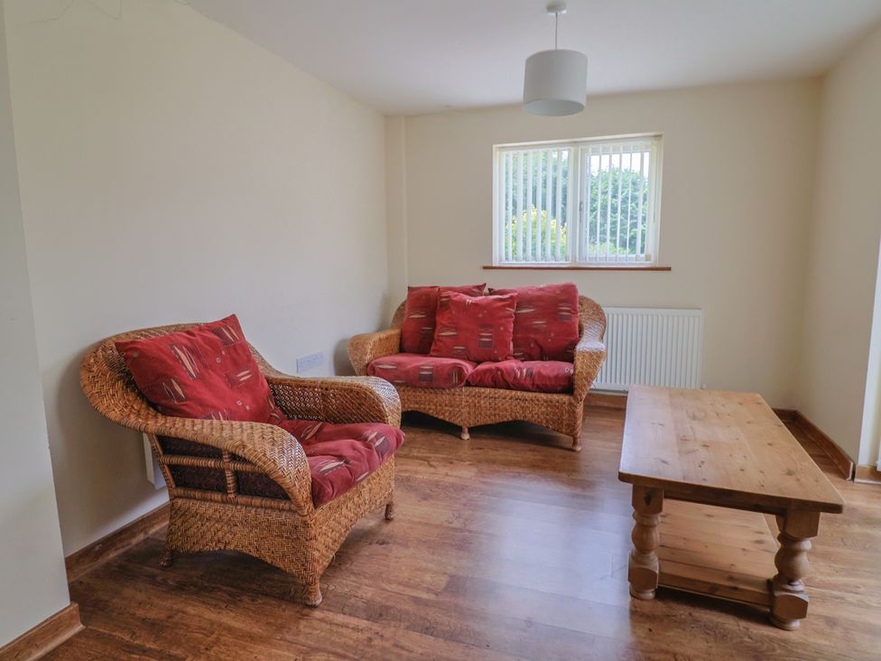 A living room with a sofa and coffee table at The Orchard Country House Rousdon