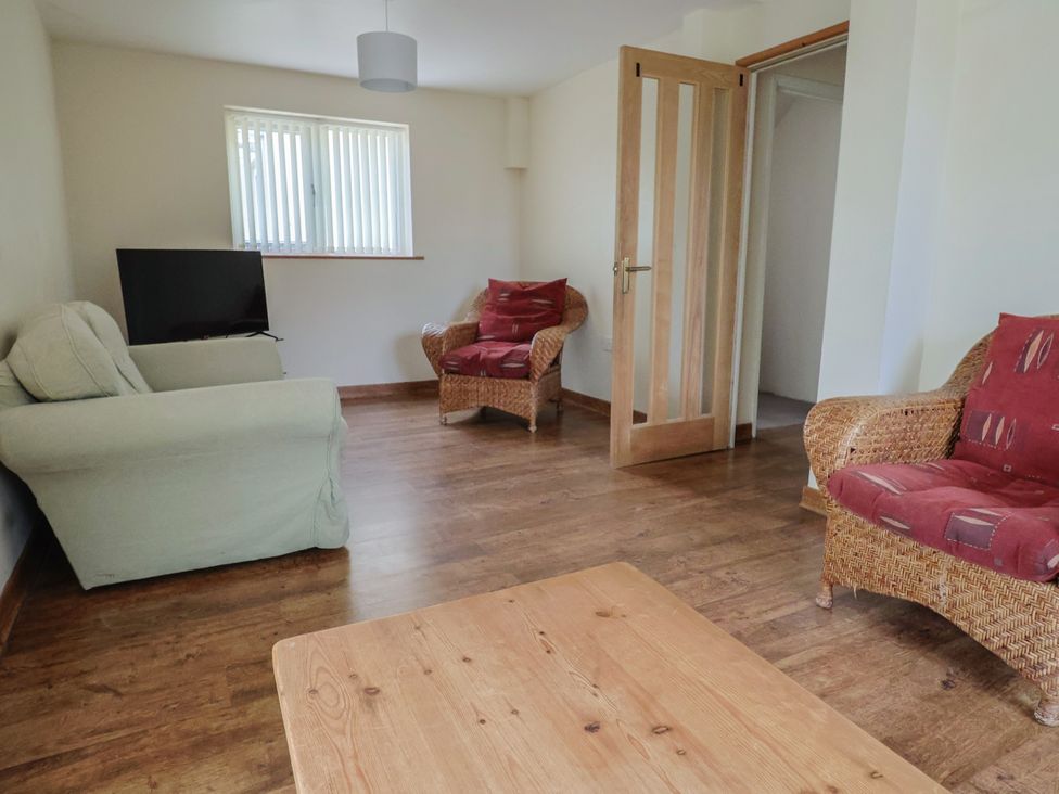 A living room with a sofa and chairs at The Orchard Country House in Rousdon