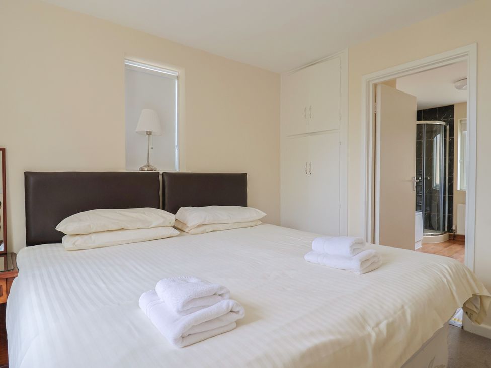 A bedroom with a bed and towels at The Orchard Country House in Rousdon