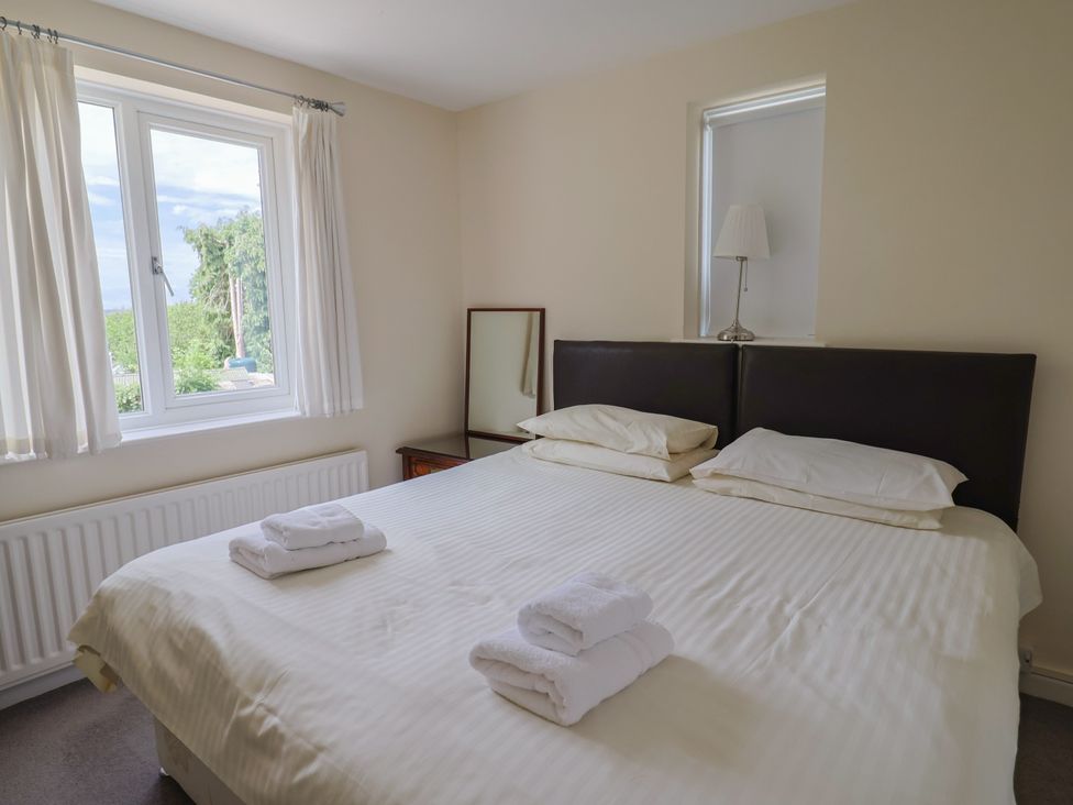 A bedroom with a double bed and a window at The Orchard Country House Rousdon