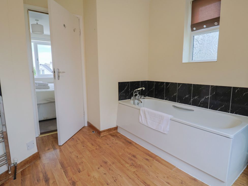 A bathroom featuring a bathtub and a window at The Orchard Country House Rousdon