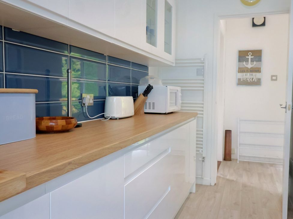 A kitchen with a countertop and appliances at High Trees Lyme Regis
