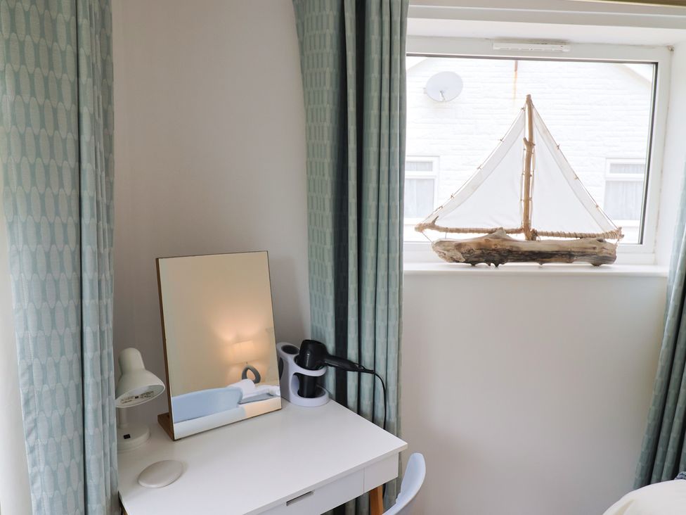 A bedroom with a desk and a mirror at High Trees in Lyme Regis