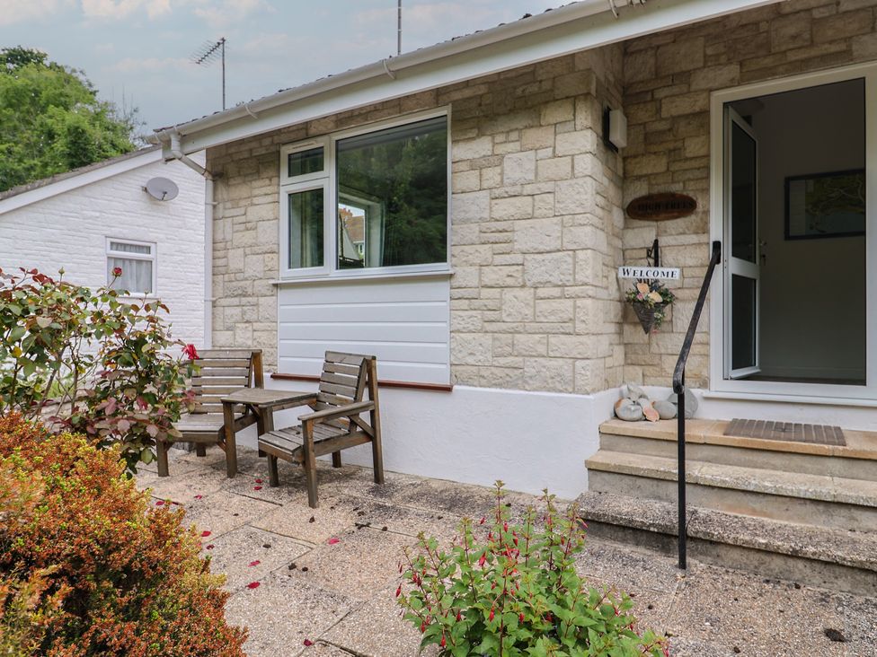 An outdoor entrance with steps and chairs at High Trees Lyme Regis