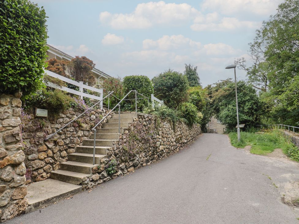 Steps leading up to a property with a stone wall at High Trees in Lyme Regis
