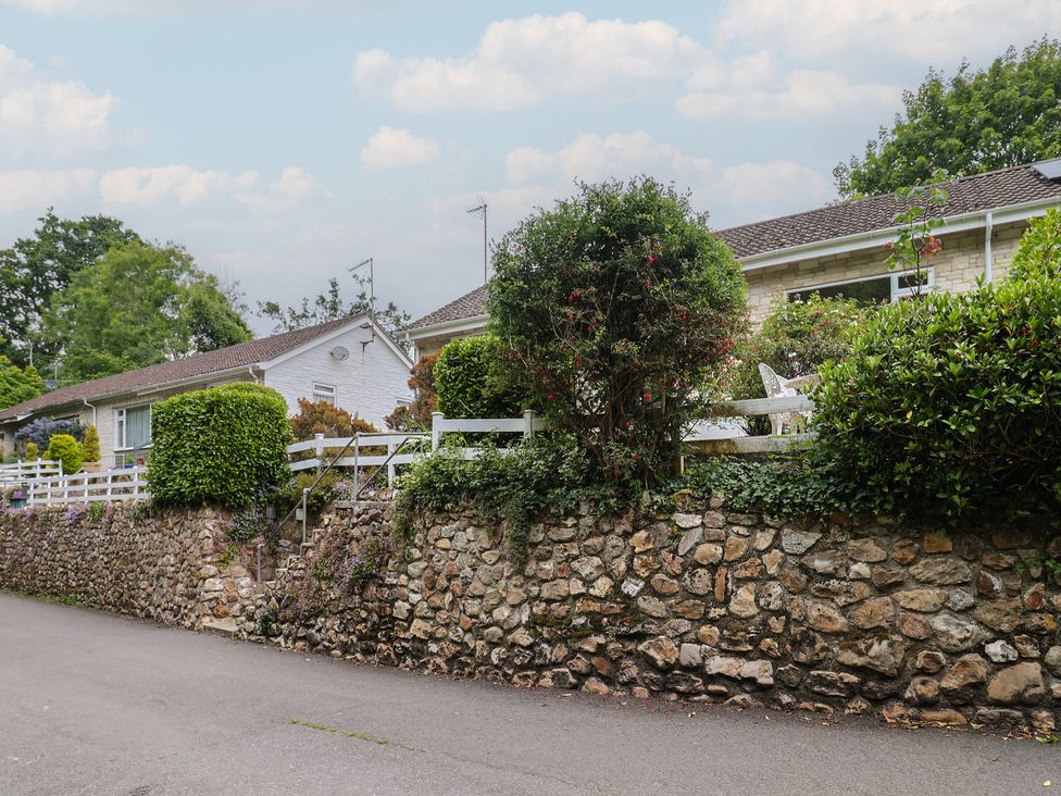 A house with a garden and a stone wall at High Trees in Lyme Regis