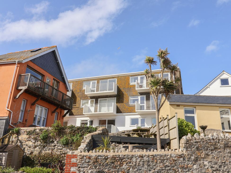 Two houses with balconies and plants at 1 Bay View Court in Lyme Regis