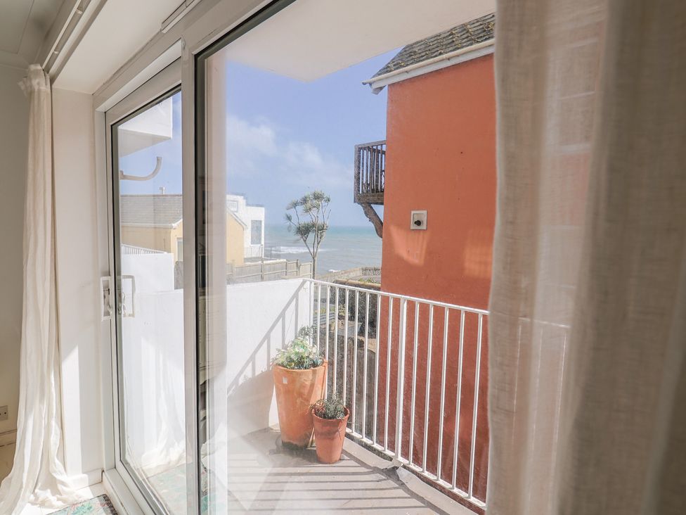 A balcony view with a planter and sliding glass door at 1 Bay View Court Lyme Regis