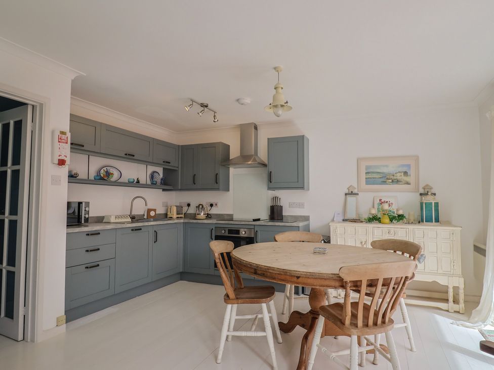 A kitchen with a round table and four chairs at 1 Bay View Court Lyme Regis
