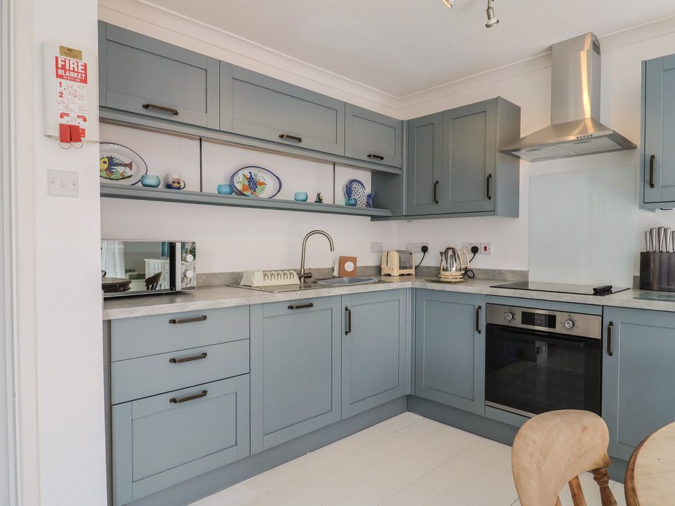 A kitchen with cabinets and appliances at 1 Bay View Court Lyme Regis