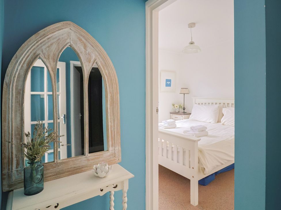 A view of a bedroom with a bed and furniture at 1 Bay View Court in Lyme Regis
