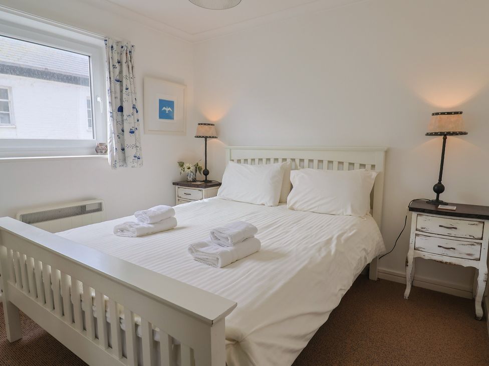 A bedroom with a bed and bedside tables at 1 Bay View Court in Lyme Regis