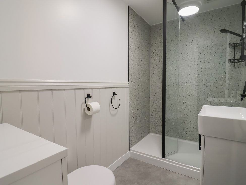 A bathroom with a shower and sink at 1 Bay View Court in Lyme Regis