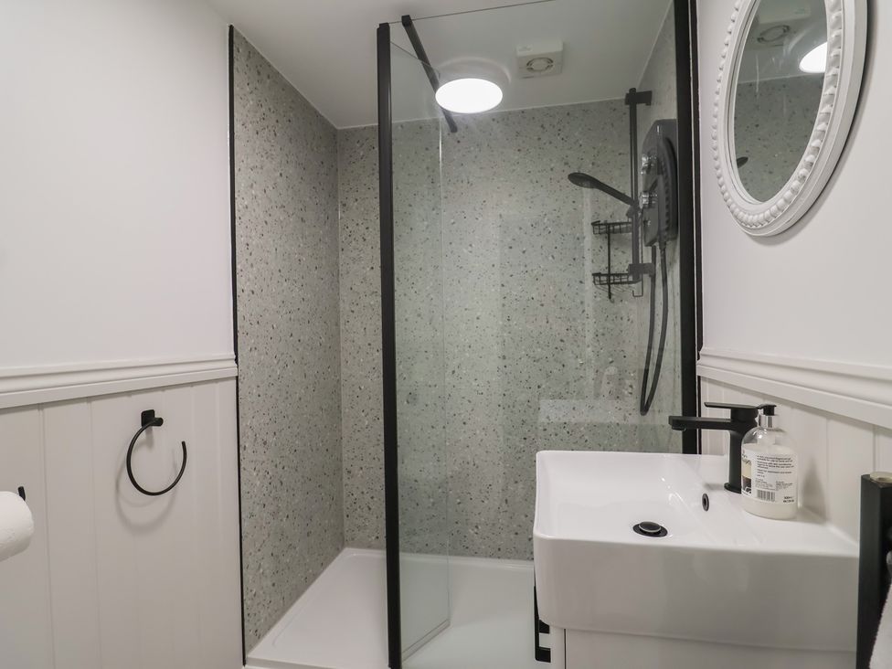 A bathroom with a shower and sink at 1 Bay View Court in Lyme Regis