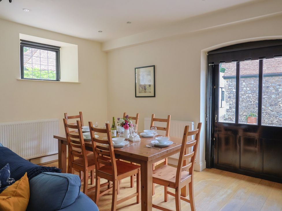 A dining room with a table and chairs at Yard Cottage in Rousdon