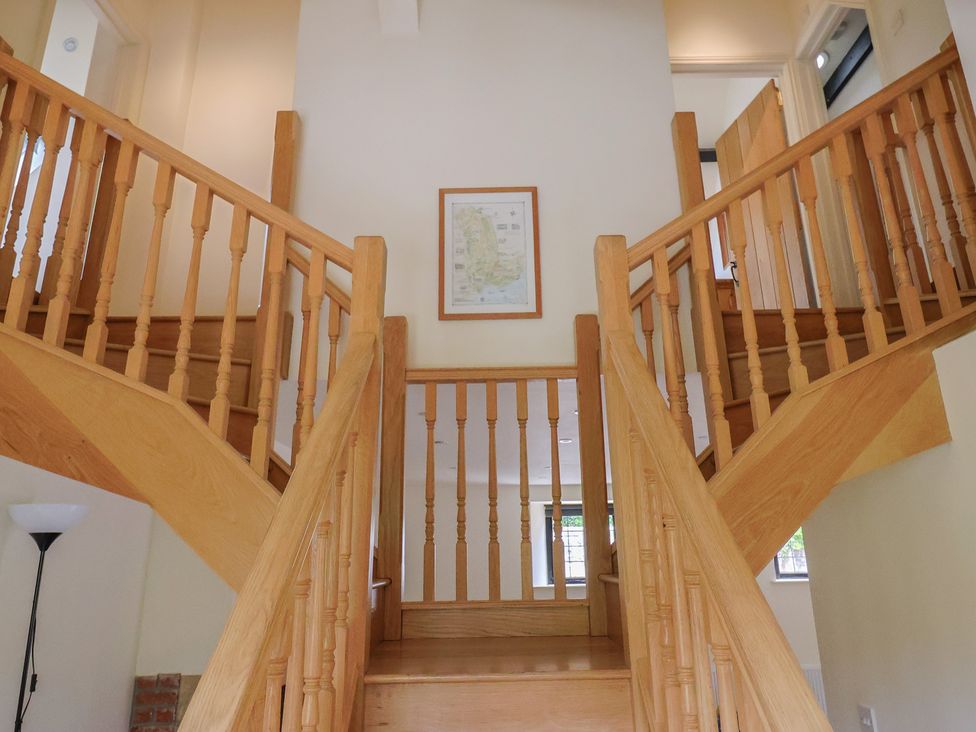 A staircase with railings leading to an upper floor at Yard Cottage in Rousdon