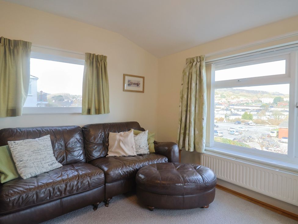 A living room with a sofa and a window at Greystones Lyme Regis