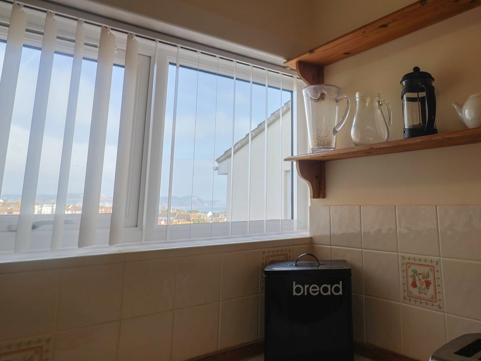 A kitchen with window and shelves at Greystones Lyme Regis